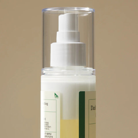 Image showing the two layers of the toner inside the bottle when they have not been mixed. The bottle has a spray cap.